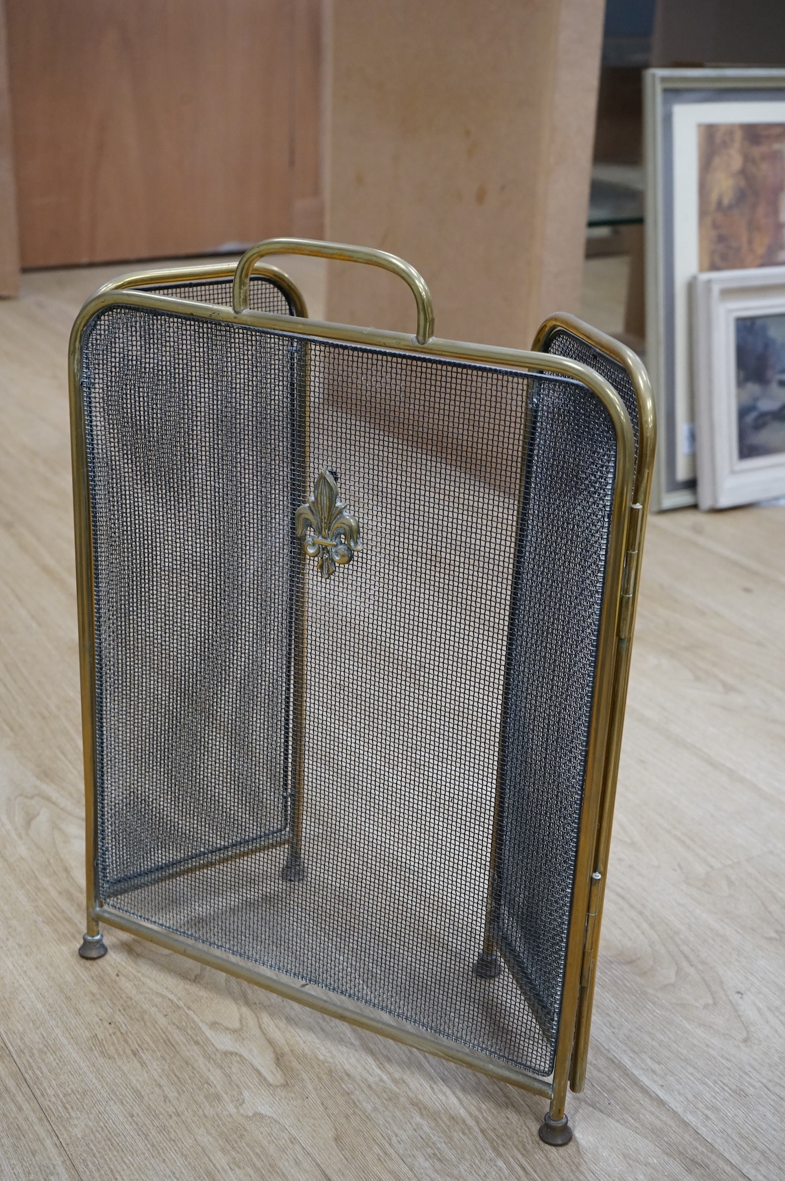 A fire brass guard, pair of candlesticks, kettle, miner's lamp etc, fire guard 54cm high.